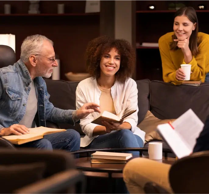 Three people reading and talking