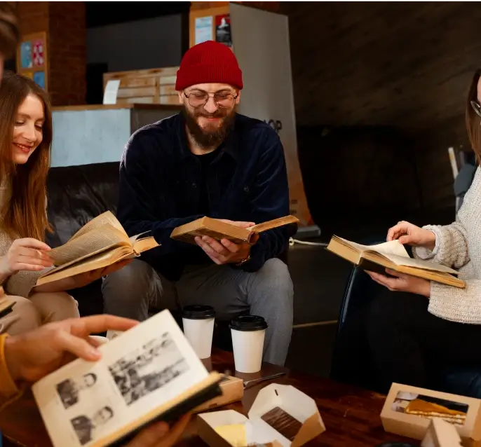 Four people reading together in a circle